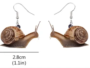 Detail view showing 2.8cm snail-shaped acrylic pendant earring with realistic brown texture