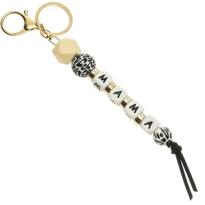 Macro view of MAMA keychain with leopard print beads and black suede leather tassel
