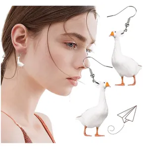 Detail of realistic white goose earrings on model showing size and lightweight acrylic material
