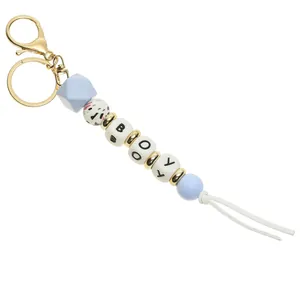 Handmade beaded keychain with gold lobster clasp and blue-white BOOY letter beads