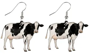Detail of creative acrylic cow pendant earrings with realistic black and white animal print