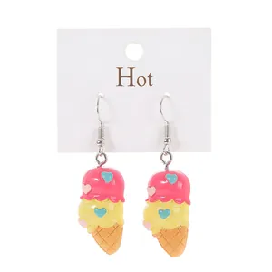 Detail showing creative dual-scoop ice cream earrings with colorful hearts on white card