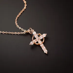 Macro shot of rose gold cross pendant necklace inlaid with sparkling cubic zirconia stones