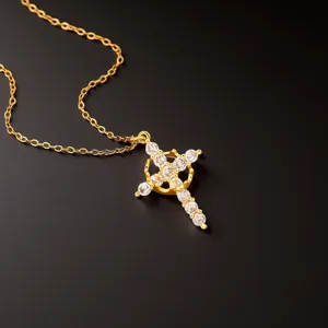 Golden cross necklace for women featuring sparkling cubic zirconia stones on black background