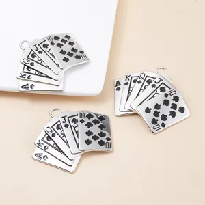 Macro detail of royal flush poker card pendant in silver alloy with black enamel fill