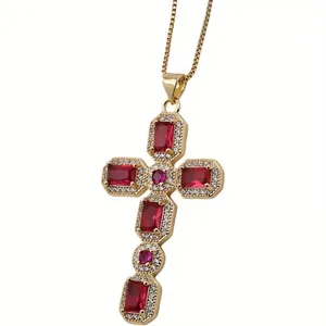 Macro detail of a gold cross pendant with red gemstones and sparkling zircon accents