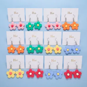 Detailed set of 12 colorful resin flower dangle earrings on a white display card