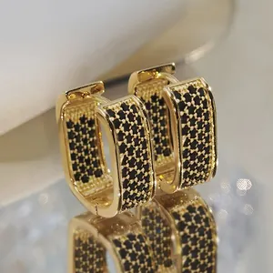 Luxe rectangular gold hoop earrings with black zircon micro-paving on reflective surface