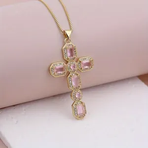 Elegant gold cross pendant with pink gemstones and micro-pave zircons on a fine chain