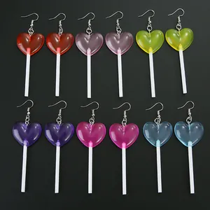 Detailed flat lay of six pairs of heart lollipop earrings in vibrant translucent colors