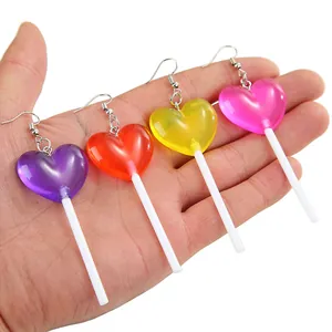 Detailed view of four heart-shaped lollipop earrings in purple, orange, yellow, and pink