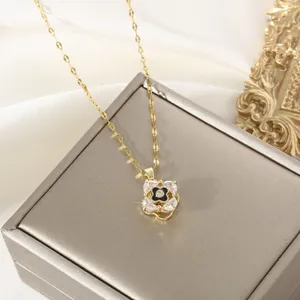 Elegant gold clover necklace with crystal petals on a premium jewelry gift box