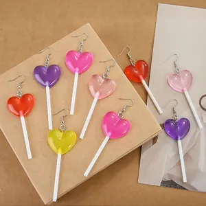 Detailed view of colorful heart-shaped lollipop earrings in vibrant acrylic material