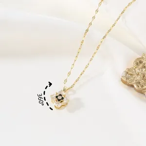 Rotating 360 gold four-leaf clover necklace with black inlay and sparkling crystals