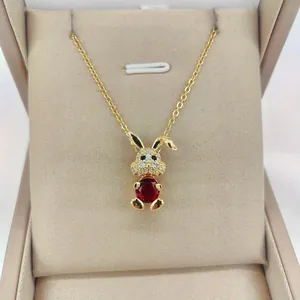 Detailed close-up of 14K gold plated rabbit pendant with pink zircon and white crystals