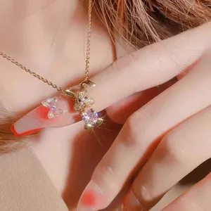 14K gold plated rabbit pendant necklace with pink zircon on a woman's neck