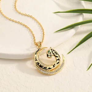 Elegant gold leopard pendant necklace with green eyes and white zircon on a leaf