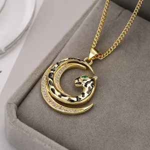 Golden necklace featuring a leopard head pendant with green eyes and crystal accents