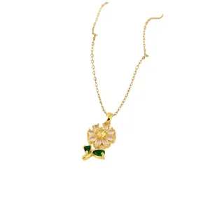 Gold sunflower pendant necklace with yellow zircon center and green gemstone leaves