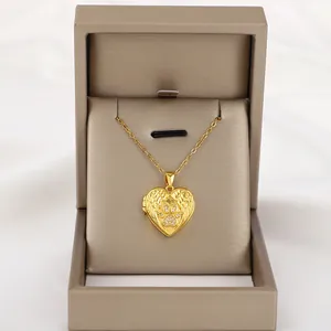 Golden heart locket necklace with angel wings and zircon paw print in a gift box
