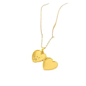 Golden heart locket necklace with wings design showing an open photo frame compartment