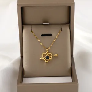 Gold arrow through heart necklace with black projection stone in a gift box