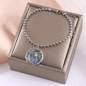 Bracciale a sfere d'argento con ciondolo a libellula e inserto in abalone su tessuto rosa