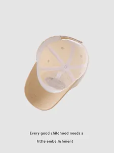 Close-up of internal structure and fine stitching on beige kids baseball cap