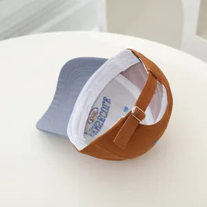 Detail view of cotton baseball cap with adjustable strap and metal buckle closure