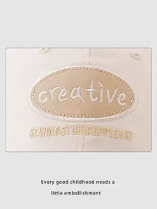 Close-up of beige cotton baseball cap with high-quality creative embroidery and fine stitching