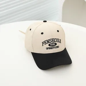Top view of two-tone kids baseball cap with detailed 1995 embroidery on white canvas
