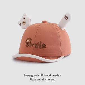 Detail of caramel baby baseball cap with Smile 3D embroidery and cute bear ears