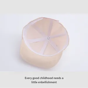 Internal view of beige baby baseball cap showing soft lining and sweatband detail
