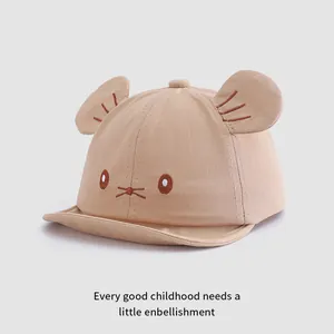Detail of light khaki baby baseball cap with cute cartoon cat ears and embroidery