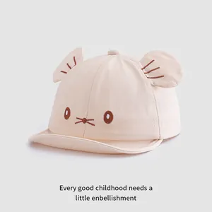 Detail of beige baby baseball cap featuring 3D animal ears and embroidered whiskers