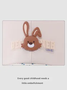 Detail of beige kids baseball cap with 3D brown rabbit patch and cute English text