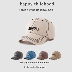 Close-up of ROK! smiley embroidery on breathable cotton baseball caps for kids