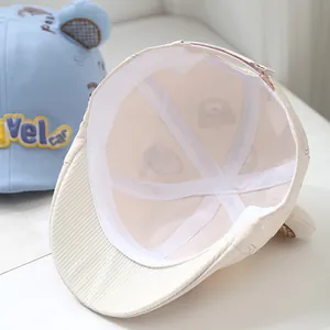 Detailed interior of a beige kids baseball cap showing breathable lining and seams