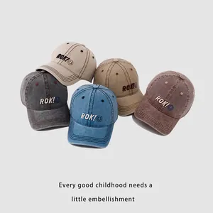 Collection of kids ROK smile baseball caps in beige, khaki, blue, and burgundy tones