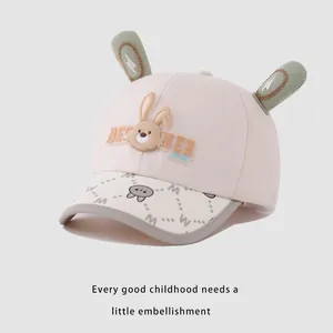 Detail of baby baseball cap with green rabbit ears and BEST NER LOVE text embroidery