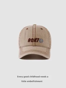 Detail of khaki washed denim baseball cap with ROK! embroidery and blue smiley face