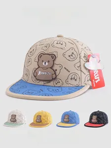 Detail view of cartoon bear pattern on beige canvas flat brim kids baseball cap