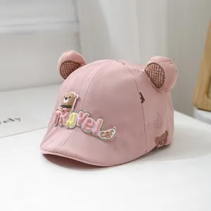 Close-up of pink baby sun hat featuring 3D bear ears and Travel Car embroidery details
