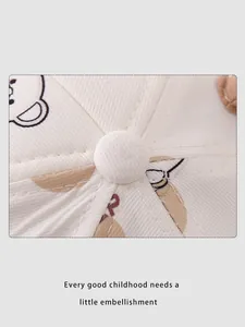 Close-up of baby baseball cap featuring cotton twill stitching and cartoon bear print