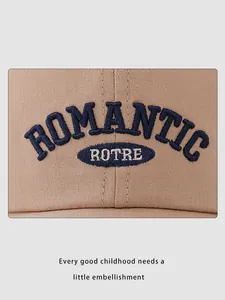 Detailed embroidery of ROMANTIC text on khaki canvas children's baseball cap