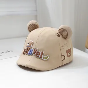 Detail of baby sun hat with 3D travel car lettering and cute bear ears on top