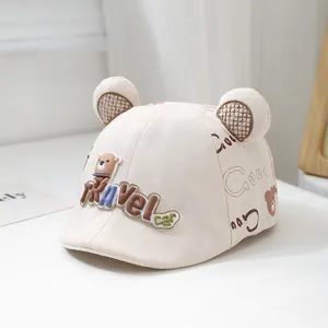Detail of beige baby sun hat featuring 3D bear ears with brown plaid inner lining