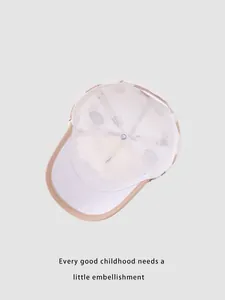 Detailed interior of beige kids baseball cap with breathable mesh and polka dot pattern