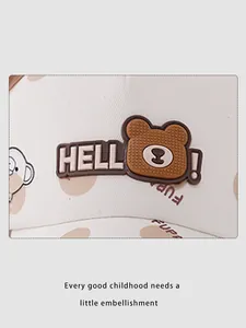 Detail of baby baseball cap with 3D silicone brown bear badge and polka dot pattern