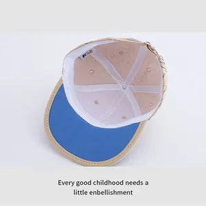 Detailed interior of kids beige baseball cap with blue brim and adjustable metal buckle